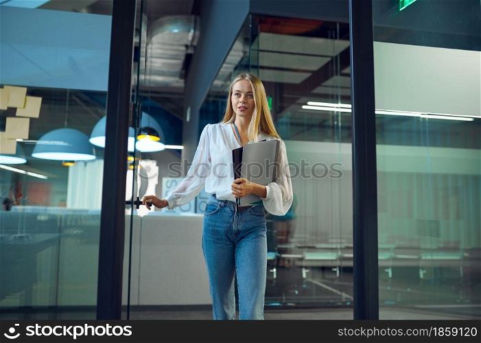 Female manager, IT office interior on background. Professional worker, planning or brainstorming. Successful businesswoman works in modern company. Female manager, IT office interior on background