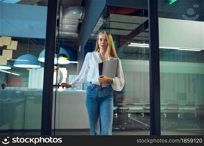 Female manager, IT office interior on background. Professional worker, planning or brainstorming. Successful businesswoman works in modern company. Female manager, IT office interior on background
