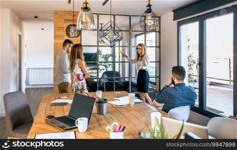 Female manager talking in a business meeting sticking notes on a glass wall. Female manager talking in a business meeting