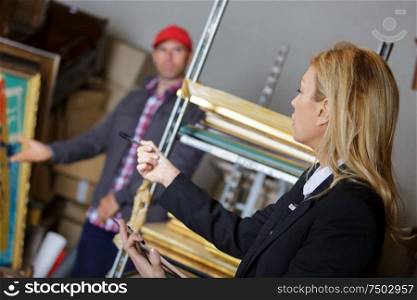 female manager talking to his worker in a warehouse
