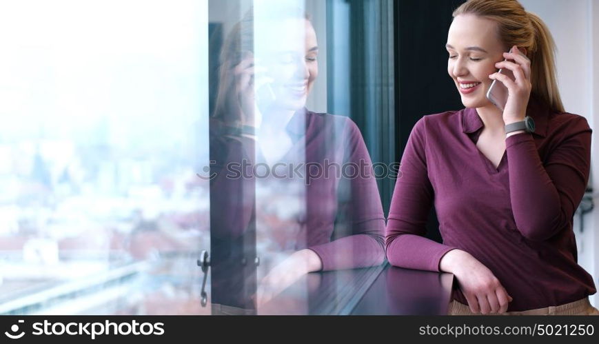 female manager using cell telephone in office interior