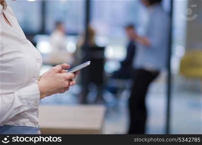 female manager using cell telephone in startup office interior