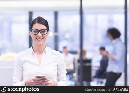 female manager using cell telephone in startup office interior