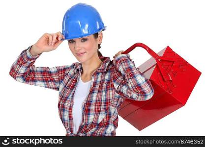 Female manual worker carrying tool box
