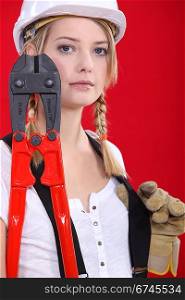 Female manual worker holding industrial cutters