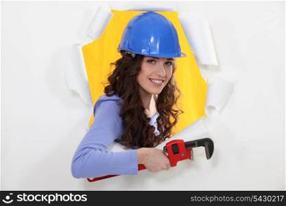 Female manual worker holding wrench