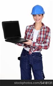 Female manual worker showing off laptop