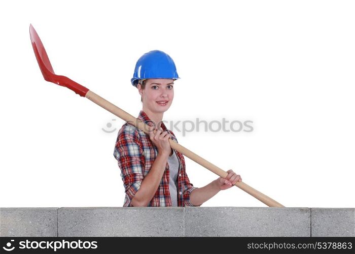 Female mason holding shovel