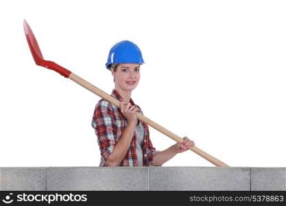 Female mason holding shovel