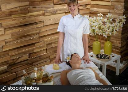 Female masseur give massage treatment in luxury health spa centre