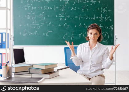 Female math teacher in front of the chalkboard 