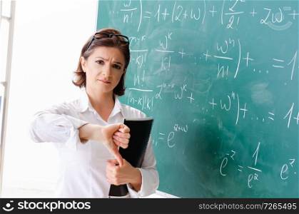 Female math teacher in front of the chalkboard 