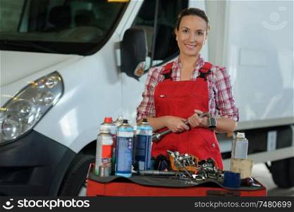 female mechanic holding a socket wrench
