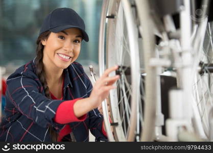 female mechanic servicing a wheelchair in the workshop