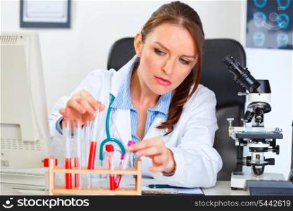 Female medical doctor working with test tube in laboratory&#xA;