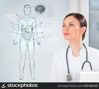 Female medical doctor working with virtual interface examining human male body