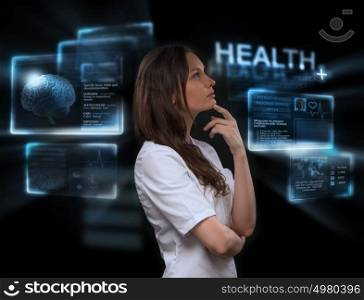 Female medical doctor working with virtual interface. Modern medical technologies concept