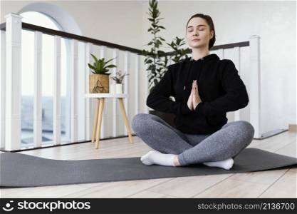 female meditating indoor