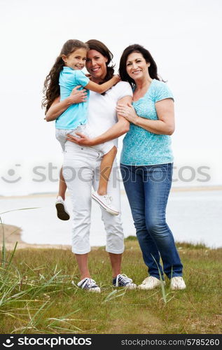 Female Members Of Multi Generation Family Standing By Sea