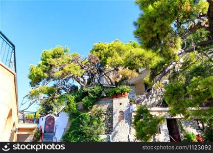 Female Monastery of St. Potapius near Loutraki, Greece against the backdrop of a blue sky and bright green Mediterranean pine, Peloponnese, Greece, August 2019, image with copy space... Monastery of St. Potapius near Loutraki, Greece.