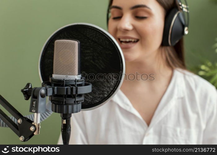 female musician singing into microphone