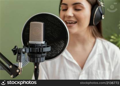 female musician singing into microphone