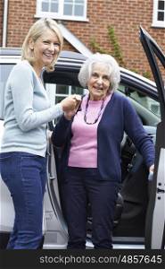 Female Neighbor Giving Senior Woman A Lift In Car