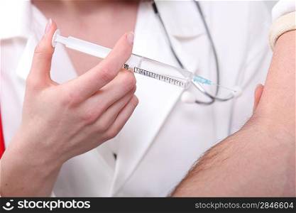 Female nurse injecting vaccine to patient