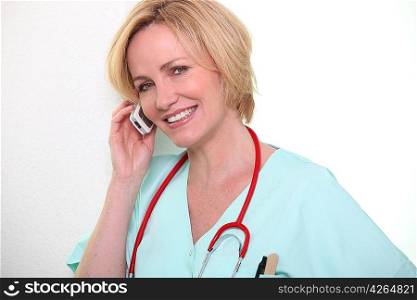 Female nurse speaking on mobile telephone