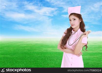 female nurse with stethoscope with green grass field and sky background