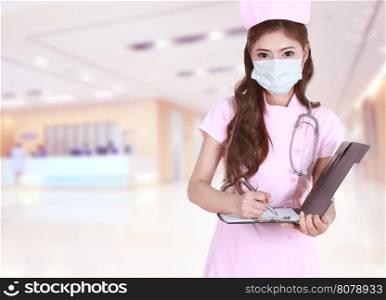 female nurse writing medical report in hospital background
