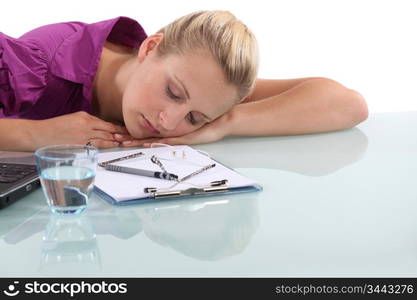 Female office worker asleep at desk