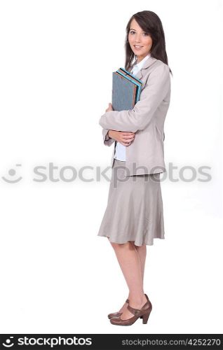 Female office worker carrying folders