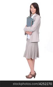 Female office worker carrying folders