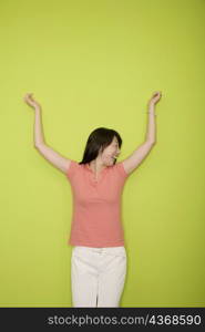 Female office worker laughing with her arms raised