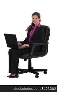 Female office worker sitting with laptop