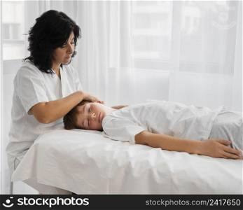 female osteopathist treating boy