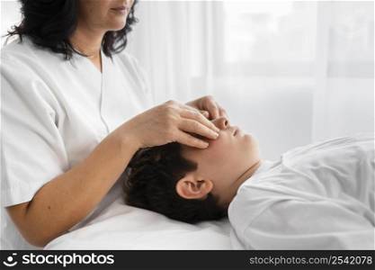 female osteopathist treating kid