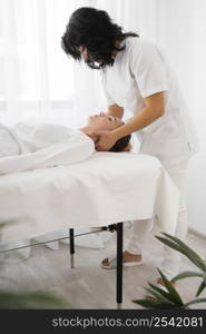 female osteopathist treating young woman hospital