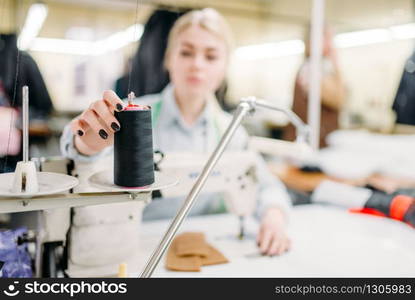 Female painter adds a color to the palette in studio. Creative paintbrush art, artist drawing portrait in class, workshop interior on background. Female painter adds color to the palette in studio