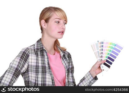 female painter holding a color chart