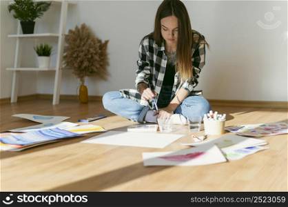 female painter sitting floor