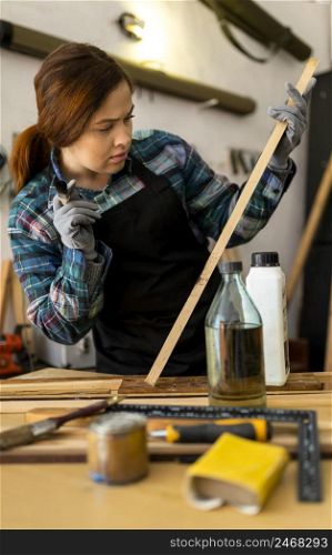 female painting wood plank