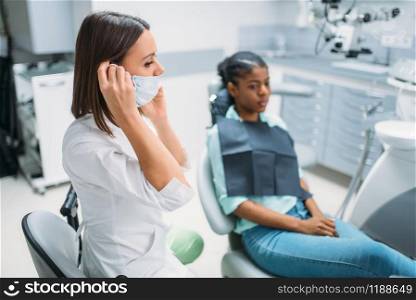 Female patient and dentist, teeth examination in dental clinic. Woman in dentistry cabinet, stomatology, tooth care. Female patient and dentist, stomatology cabinet