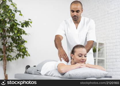 female patient being checked by male physiotherapist