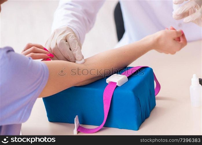 Female patient during blood test sampling procedure 