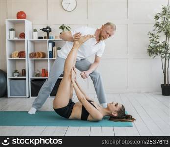 female patient physiotherapy doing exercises with male physiotherapist