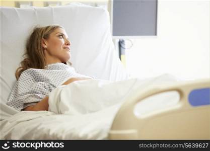 Female Patient Resting In Hospital Bed