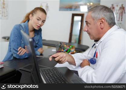 female patient taking an appointment at the hospital reception
