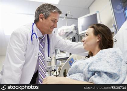 Female Patient Talking To Male Doctor In Emergency Room